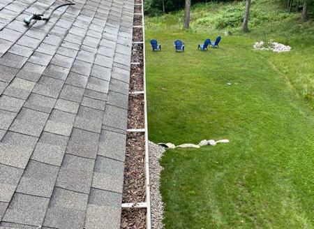 Soft wash removing black streaks from michigan asphalt shingle roof